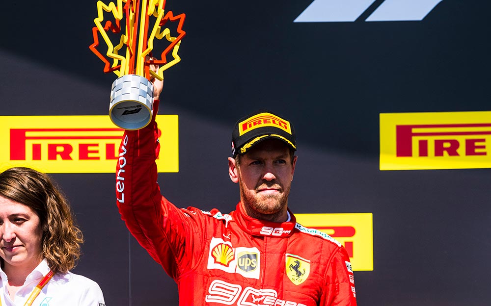 不満な表情で2位トロフィーを掲げるフェラーリのセバスチャン・ベッテル、2019年F1カナダGP決勝レースでの表彰台