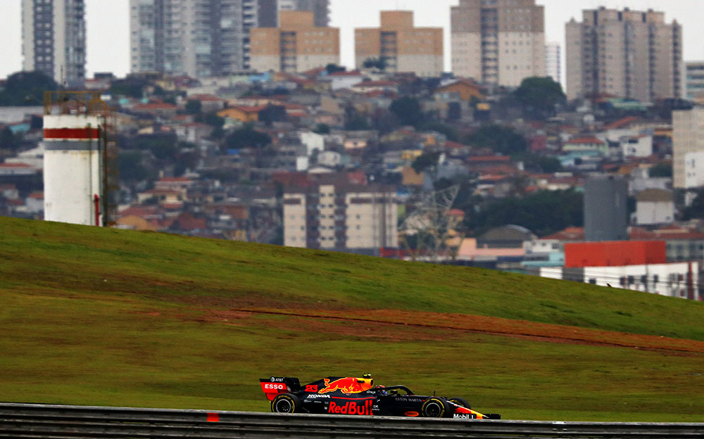 サンパウロの町並みを背景にインテルラゴス・サーキットを走行するレッドブル・ホンダのアレックス・アルボン、2019年F1ブラジルGPフリー走行2