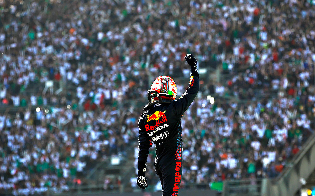 手を挙げてグランドスタンドのファンの声援を応えるレッドブル・ホンダのセルジオ・ペレス、2021年11月7日F1メキシコGP決勝レースにて