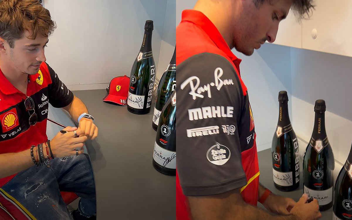 FERRARI TRENTO（フェッラーリ・トレント）のセレブレーションボトルにサインするスクーデリア・フェラーリのシャルル・ルクレールとカルロス・サインツ、2022年F1日本GP