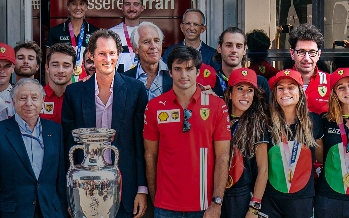 フェラーリのホスピタリティの前での集合写真に加わるジョン・エルカーン会長とマッティア・ビノット代表、2021年9月12日F1イタリアGP
