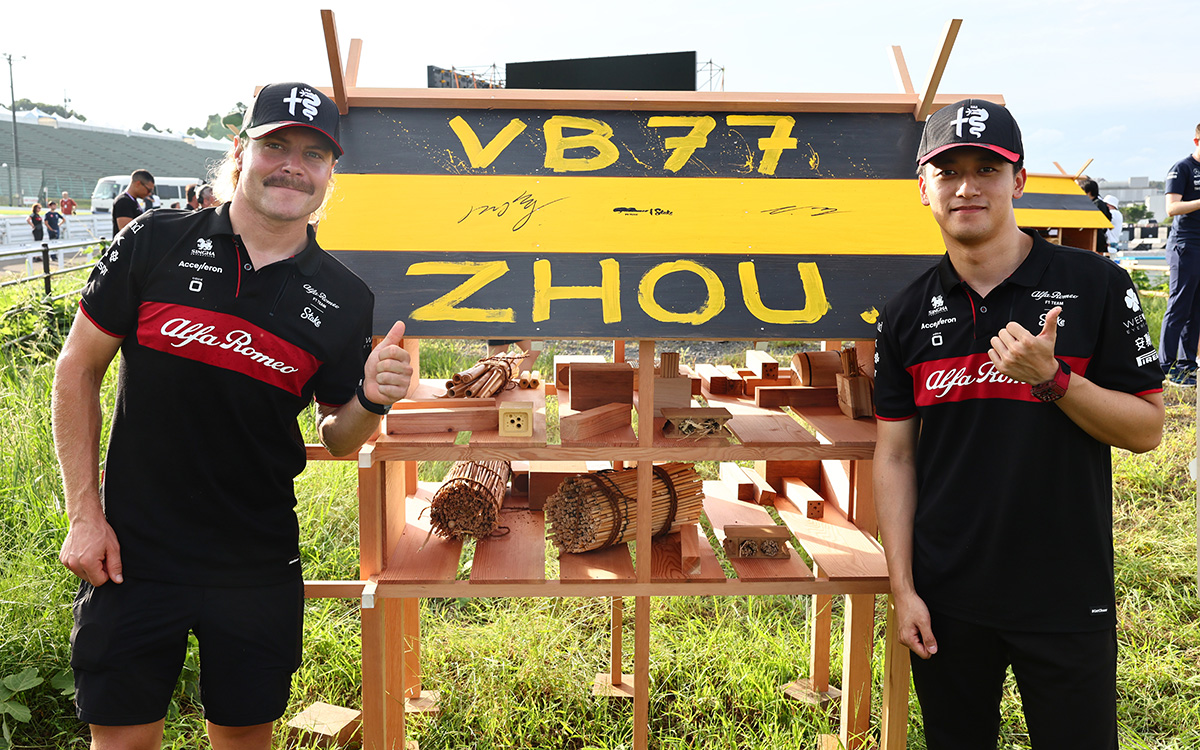 鈴鹿サーキットのターン2に設置されたセバスチャン・ベッテルの「Buzzin’ Corner」プロジェクトでインセクトハウスと写真を撮るアルファロメオのバルテリ・ボッタスと周冠宇、2023年9月21日(木) F1日本GP