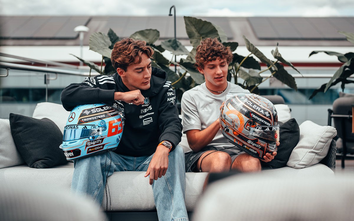 お互いのヘルメットを見せ合うメルセデスのジョージ・ラッセルとアンドレア・キミ・アントネッリ、2025年F1イギリスGP